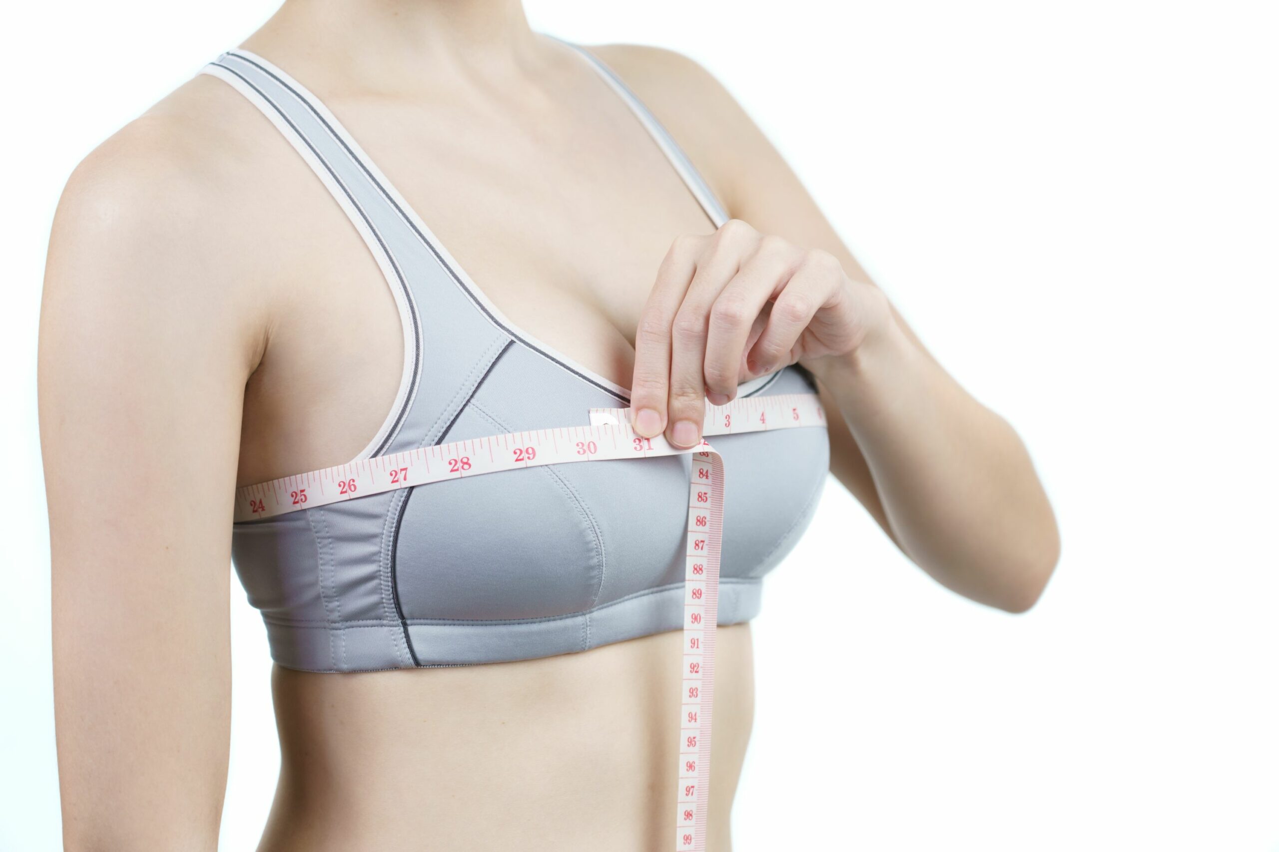 woman-measuring-her-chest-breast-implant-surgery